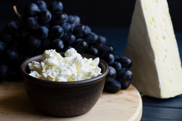cheese, grapes, on a wooden board