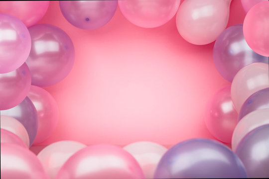 Pink background with pink and purple balloons. Bright background for celebration.