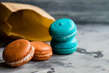 Colorful macaroons. Sweet macarons on retro dark background with copy space. Top view, Holiday time concept