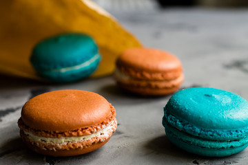 Colorful macaroons. Sweet macarons on retro dark background with copy space. Top view, Holiday time concept