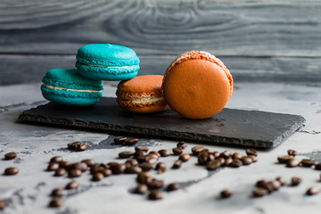 Colorful macaroons. Sweet macarons on retro dark background with copy space. Top view, Holiday time concept