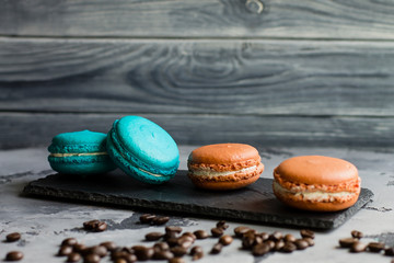 Colorful macaroons. Sweet macarons on retro dark background with copy space. Top view, Holiday time concept