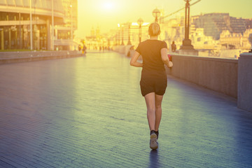 Londoner lifestyle women running near tower bridge. Female runner jogging training in city Fitness...