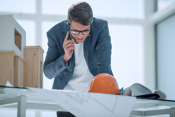designer discussing the details of the project on a mobile phone.