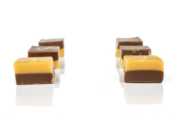 Group of six whole sweet brown caramel chocolate candy isolated on white background