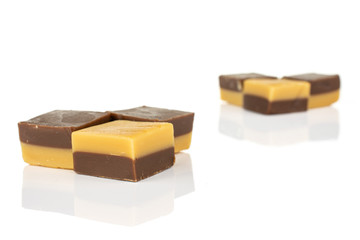 Group of six whole sweet brown caramel chocolate candy in two groups isolated on white background