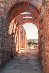 Naklejka premium MERIDA, EXTREMADURA, SPAIN - AUGUST 08, 2019: Roman Theatre and Amphitheatre. Tourists in the architectural and monumental complex of the ancient and picturesque streets of Merida