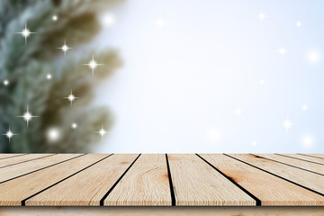 abstract blur christmas pine leaves  tree in home interior background with blinking star and aged wood perspective tabletop for show,ads,design product on display concept in merry xmas  concept