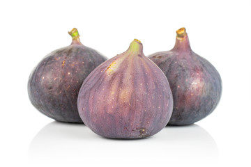 Group of three whole fresh purple fig isolated on white background