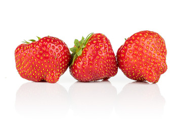 Group of three whole fresh red strawberry in row isolated on white background