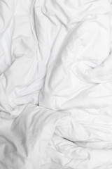 Top view of a messy bedding sheet after night sleep,white fabric crease