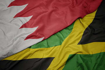 waving colorful flag of jamaica and national flag of bahrain.