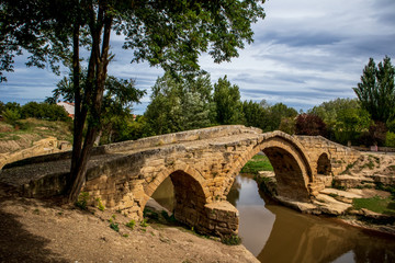 Fototapeta na wymiar Puente Romano del Priorato - Roman bridge over Tiron River near Cihuri town, La Rioja, Spain