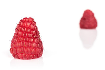 Group of two whole fresh red raspberry isolated on white background