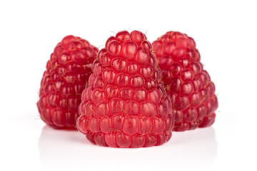Group of three whole fresh red raspberry isolated on white background