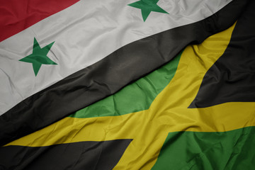waving colorful flag of jamaica and national flag of syria.