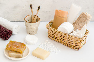Bathroom accessories set with tooth brushes and towels on white background