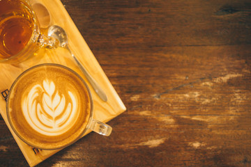 Coffee Latte art cup top view on old wooden  on the wooden background