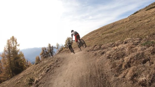 Following two bikers on a trail
