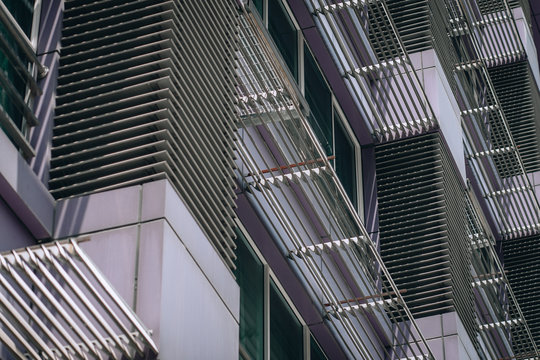 Kuala Lumpur, Malaysia – March 15, 2019. Low Angle View Of The Grey Urban Facade Decorated With Bar Screens; Wallpaper. Modern Architecture Concept.