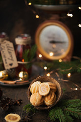 Christmas dessert cookies nuts with boiled condensed milk on a dark background with garlands and Christmas decorations.