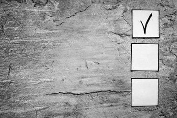 Check mark in check-box of check list on grey background top view copy space