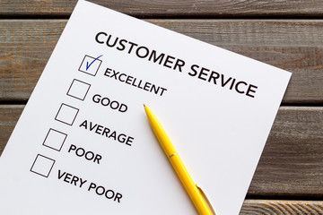 Customer service form with mark Exellent close up on dark wooden background top view