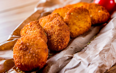 Fried crispy chicken nuggets on wooden table background