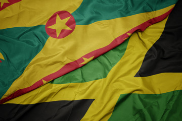 waving colorful flag of jamaica and national flag of grenada.