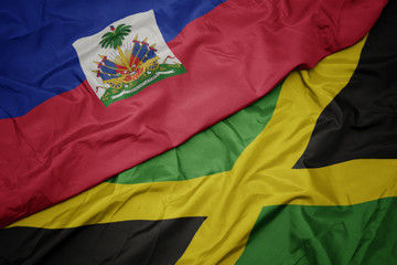 waving colorful flag of jamaica and national flag of haiti.