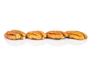 Group of four whole dry brown pecan nut isolated on white background
