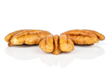 Group of three whole dry brown pecan nut isolated on white background