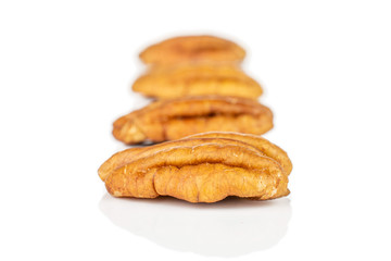 Group of four whole dry brown pecan nut isolated on white background