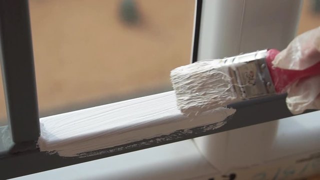 Painting metal structures with white paint using a brush