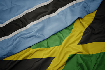 waving colorful flag of jamaica and national flag of botswana.