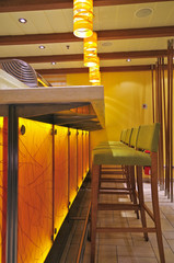 Modern interior design inside Japanese Asian Sushi bar speciality restaurant with stuhls and lamps...