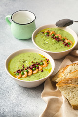 Green peas soup with shrimps, pink pepper
