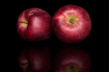 Group of two whole fresh apple red delicious isolated on black glass
