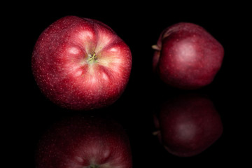 Group of two whole fresh apple red delicious isolated on black glass