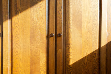Brown wooden closet doors, oak luxury design beauty with sunlight and shadows