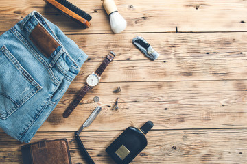 men accessories with jeans and perfume on desk
