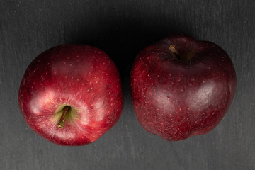 Group of two whole fresh apple red delicious flatlay on grey stone