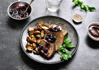 Cooked beef with mushrooms and blueberry sauce