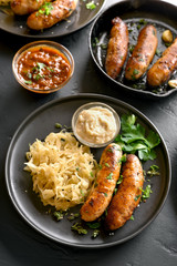 Fototapeta premium Grilled sausages with sauerkraut and horseradish