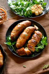 Roasted sausages in frying pan