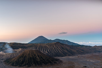 Obraz premium Twilight blue hour over Mount Bromo caldera with Semeru volcano and ridged volcanic slopes, Tengger, East Java, Indonesia