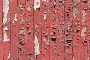 Cracked paint on a wooden surface,Red cracked paint on wooden background