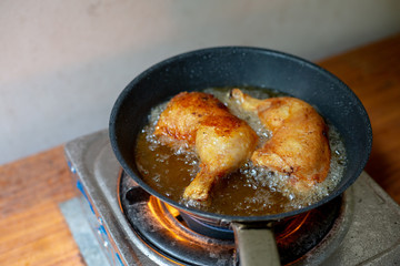 Fry the chicken in a pan with boiling oil.