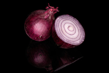 Group of one whole one half of tasty onion red isolated on black glass
