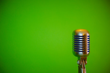 retro microphone, green background, placed on the right